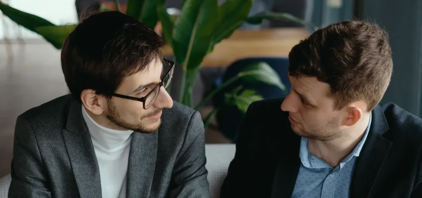 two-young-businessman-having-successful-meeting-restaurant